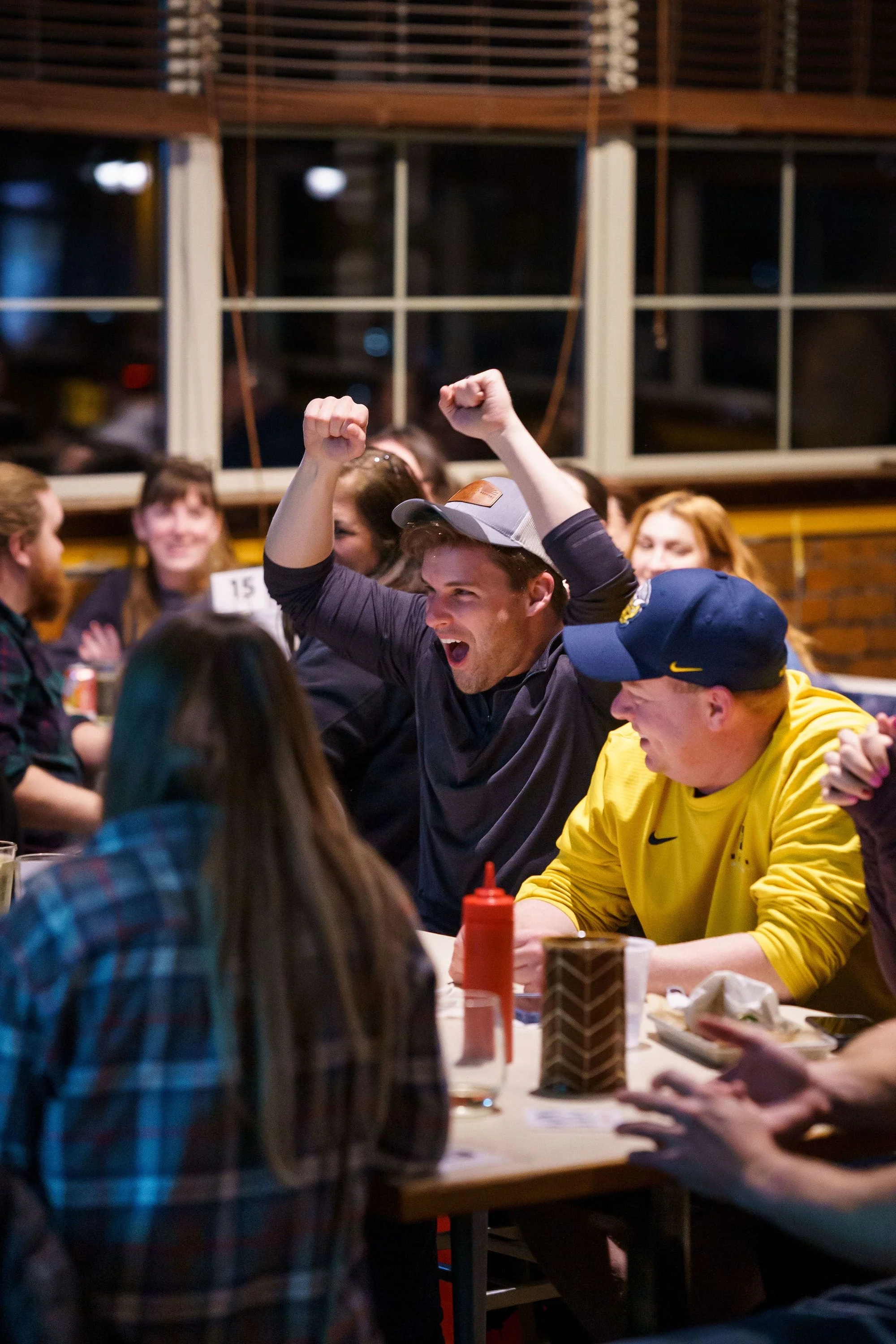 Person cheering at a Sporcle pub trivia event.